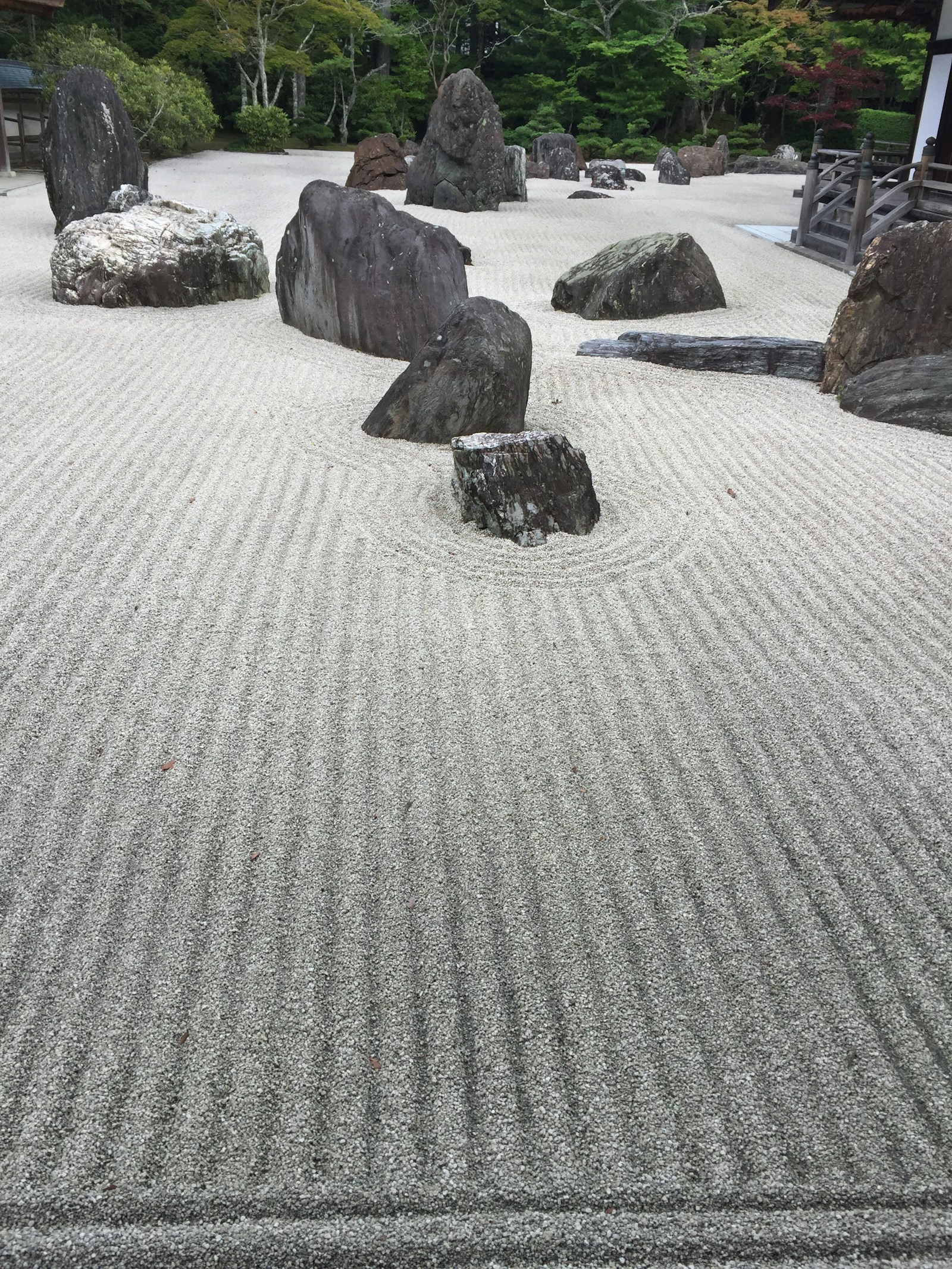 Raked gravel and stones in a Japanese zen garden Raked gravel and stones in a Japanese zen garden